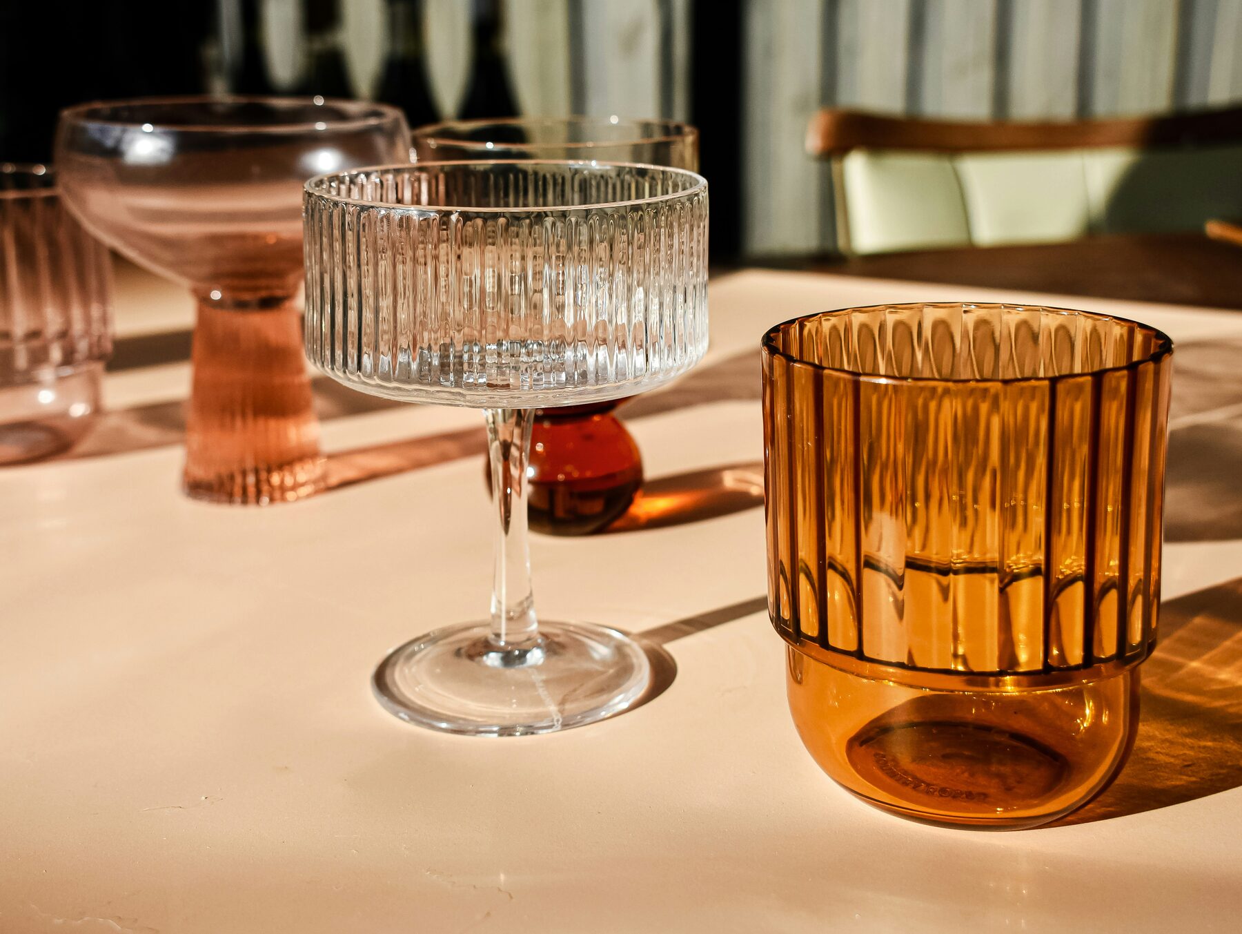 Assorted ribbed cocktail glassware on a table