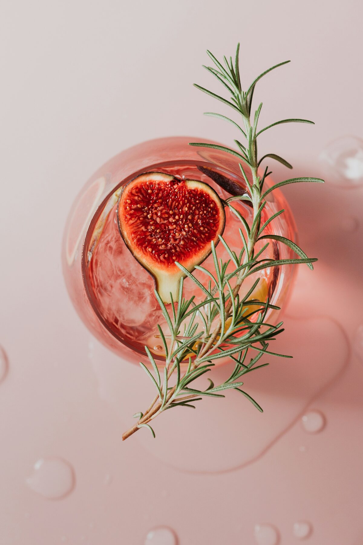 Cocktail with fig and rosemary garnish